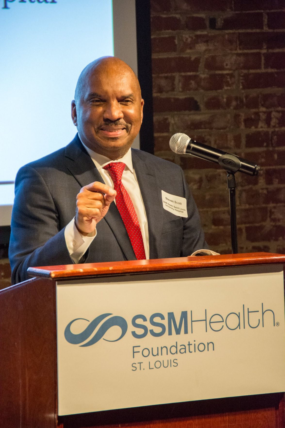Steven Scott, President of SSM Health Saint Louis University Hospital speaks at the event